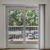 A white door with a glass window is open.